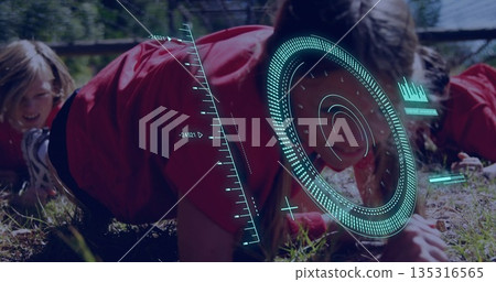 Crawling kids in red-and-black sportswear under rope net on grassy field, with teal HUD overlay 135316565