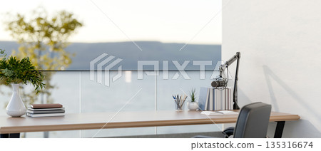 Podcast mics aside books and stationary on wooden table with glass partitions in a room or office. 135316674