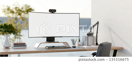 White screen computer and stationary on wooden table with glass partitions in study room or office. 135316675