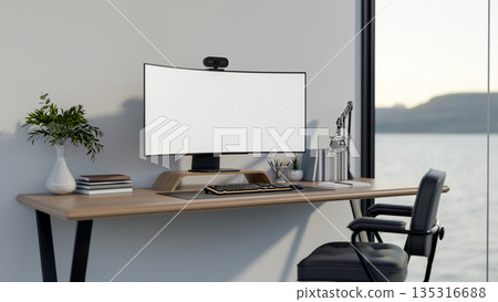 White curved screen computer with webcam and mic on wooden table and armchair in a room or office. White curved screen computer with webcam and mic on wooden table and armchair in a room or office. 135316688