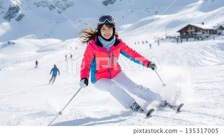 A woman skiing down a snowy field 135317005