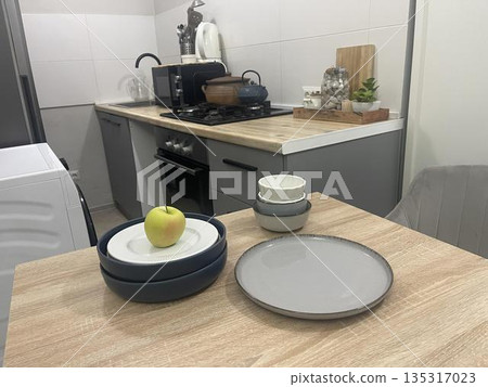 blue plates on the table in the kitchen blue plates on the table in the kitchen 135317023