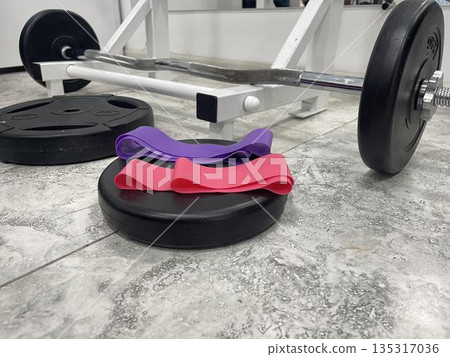 elastic resistance bands near the weight barbell 135317036