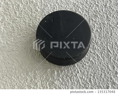 hockey puck on a gray background 135317048