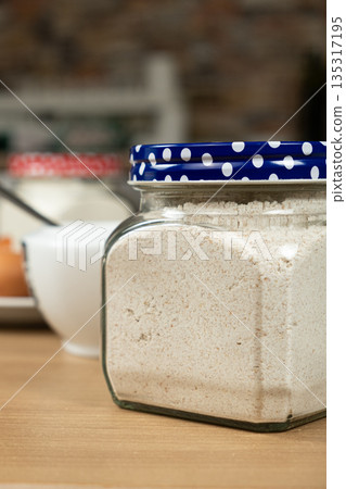 Whole wheat flour in a glass jar for making homemade healthy dough. Whole wheat flour in a glass jar for making homemade healthy dough. 135317195