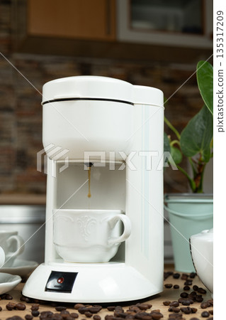Coffee brewing process in a coffee machine, hot coffee is poured into a cup. Coffee brewing process in a coffee machine, hot coffee is poured into a cup. 135317209