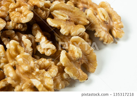 Group of organic walnut halves healthy snack on white background 135317218