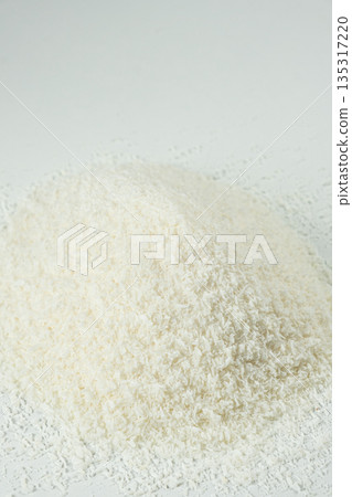 Pile of coconut flakes on white background macro 135317220