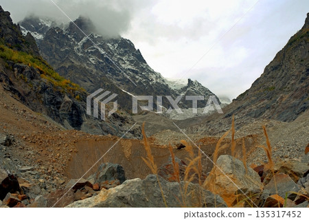 Chalaadi Glacier, ice, glacial flour, moraine, and snow in the Caucasus Mountains. Mestia, Svaneti, Georgia. 135317452
