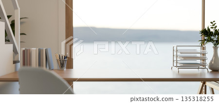 Wooden table with stationary aside staircase and window wall in a room with sea and mountain view. 135318255