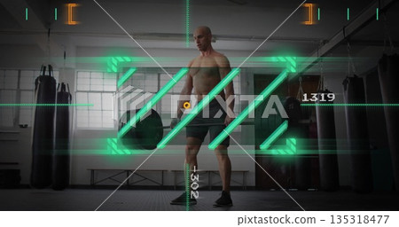 Holding loaded barbell shirtless man preparing deadlift in gym, with punching bags and AR overlay 135318477