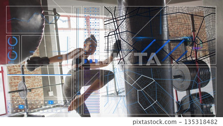 Kicking punching bag, female athlete in sports bra, leggings at gym studio, with tracking overlay 135318482