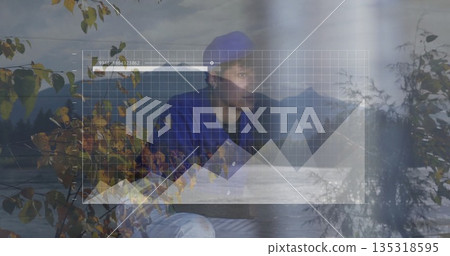 Standing person wearing blue beanie and jacket at autumn lakeside, with digital interface overlay Standing person wearing blue beanie and jacket at autumn lakeside, with digital interface overlay 135318595