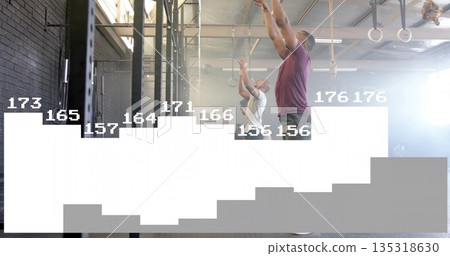 Reaching training partners pulling metal pull-up rig in fitness gym, with rings and plyo box Reaching training partners pulling metal pull-up rig in fitness gym, with rings and plyo box 135318630