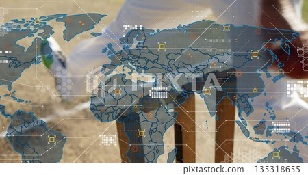 Digging man in jeans, boots planting guarded sapling with shovel in field, digital map, copy space Digging man in jeans, boots planting guarded sapling with shovel in field, digital map, copy space 135318655