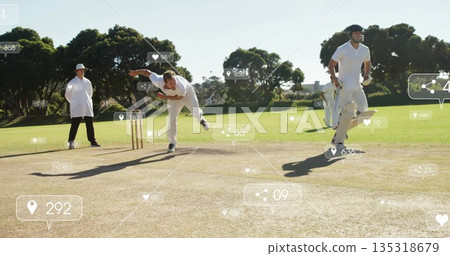 Delivering bowler in white uniform throwing ball on pitch, with stumps and digital icons 135318679