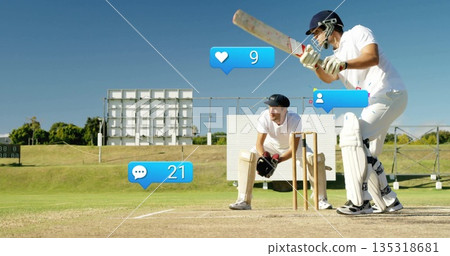 Two cricketers in white uniforms holding bat by stumps on pitch, with social icons, copy space 135318681