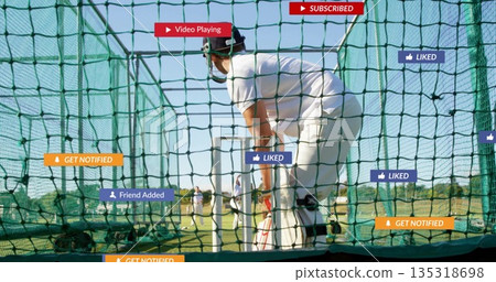 Batting cricketer wearing uniform, helmet, pads and gloves in net cage, with social media overlays 135318698