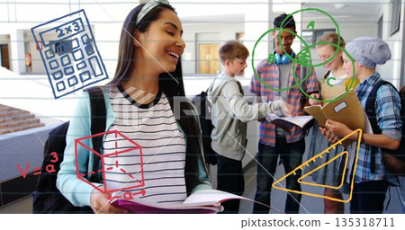 Standing Hispanic teenager holding notebook and smiling in school hallway, with math diagrams 135318711