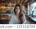 Attractive Woman Smiling In Cozy Modern Cafe Interior 135318789