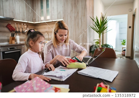 Creative moments shared between mother and daughter at home learning activities 135318972