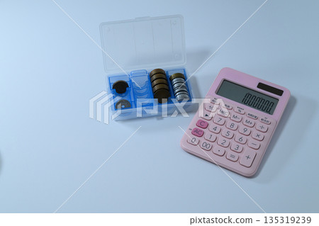 Calculator and Japanese yen coins in a coin case Calculator and Japanese yen coins in a coin case 135319239