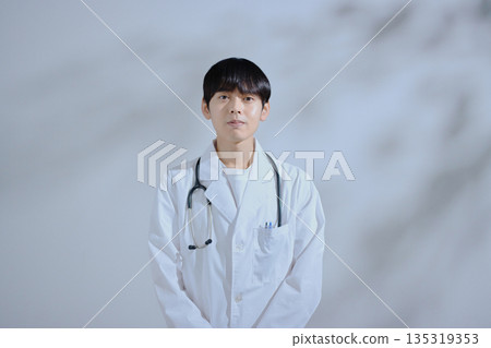 Young male doctor in white coat 135319353