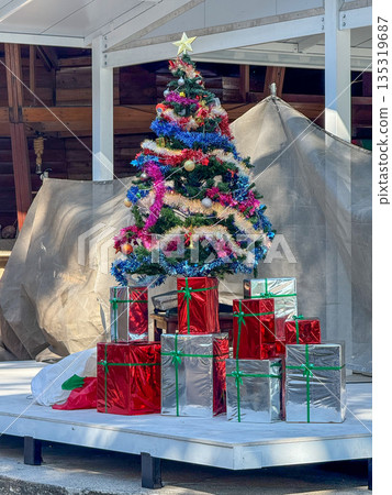 Christmas Tree With Wrapped Gift Boxes On Stage 135319687