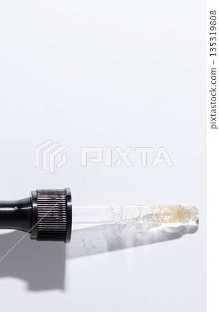 Liquid cosmetic product for the skin or medicine in a pipette. Copy space Liquid cosmetic product for the skin or medicine in a pipette. Copy space 135319808