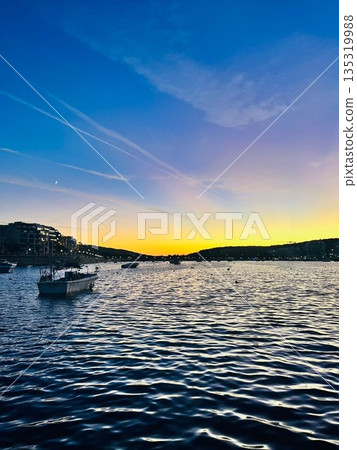 The Maltese sea at dusk and its gently swaying water surface The Maltese sea at dusk and its gently swaying water surface 135319988