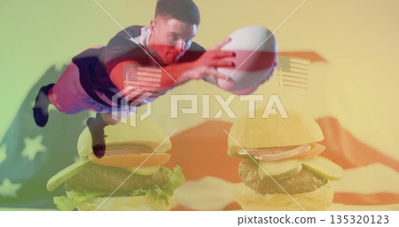 Diving athlete wearing jersey and shorts leaping in studio, with football, hamburgers, US flag 135320123