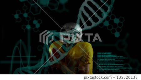 Football player in helmet and yellow jersey standing in virtual interface, with DNA helix and code Football player in helmet and yellow jersey standing in virtual interface, with DNA helix and code 135320135