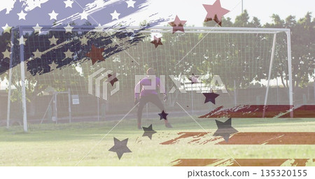 Standing teenage goalkeeper guarding goal on field, with purple jersey, gloves and flag art overlay Standing teenage goalkeeper guarding goal on field, with purple jersey, gloves and flag art overlay 135320155