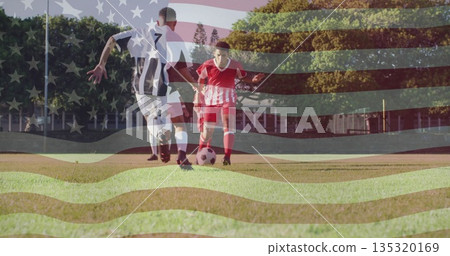 Dribbling male soccer athlete in red kit controlling ball on grassy sports pitch, with flag overlay 135320169