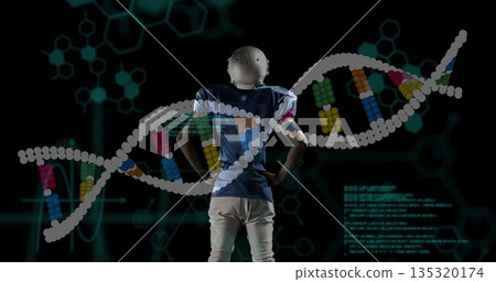 Standing helmeted player in jersey facing away in digital lab, showing DNA helix and glowing code Standing helmeted player in jersey facing away in digital lab, showing DNA helix and glowing code 135320174
