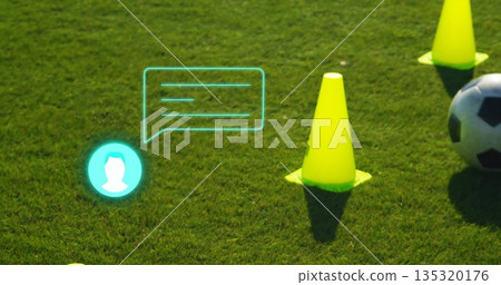 Featuring bright yellow training cone standing on turf with turquoise digital icons, soccer ball 135320176