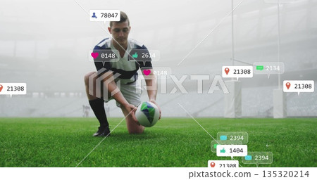 Kneeling rugby player in striped jersey placing rugby ball on pitch at stadium, with floating icons 135320214