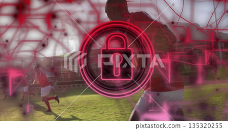 Neon red padlock icon hovering over soccer field under network overlay and sprinting in red jerseys 135320255