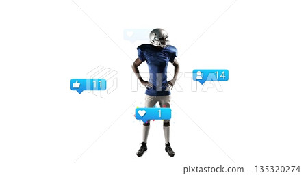 Posing football player wearing silver helmet and blue jersey in studio, with notification icons Posing football player wearing silver helmet and blue jersey in studio, with notification icons 135320274