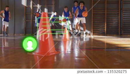Dribbling basketballs, six men maneuvering around orange traffic cones in school gym, with gym bars Dribbling basketballs, six men maneuvering around orange traffic cones in school gym, with gym bars 135320275