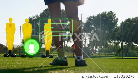 Displaying lower legs wearing shorts, cleats on turf with yellow dummies and green callouts Displaying lower legs wearing shorts, cleats on turf with yellow dummies and green callouts 135320276