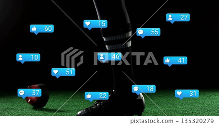 Balancing player's foot standing on turf, with socks, cleats, red-black soccer ball and blue icons Balancing player's foot standing on turf, with socks, cleats, red-black soccer ball and blue icons 135320279