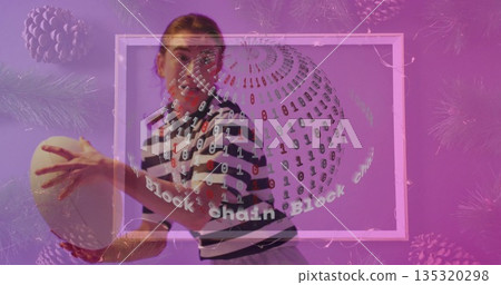 Striking woman in striped shirt holding rugby ball in studio, with binary sphere and pine branches Striking woman in striped shirt holding rugby ball in studio, with binary sphere and pine branches 135320298