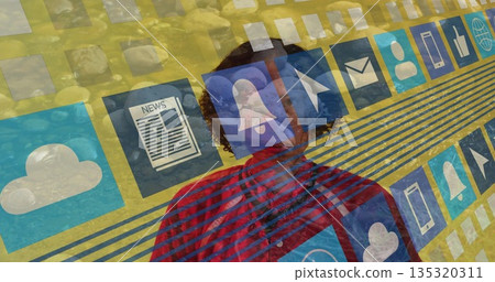 Standing woman wearing red plaid shirt in studio, showing digital cloud, news and smartphone icons 135320311