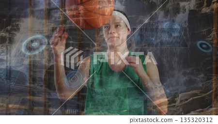 Spinning orange basketball on fingertip, athlete in green jersey at waterfall with digital graphics Spinning orange basketball on fingertip, athlete in green jersey at waterfall with digital graphics 135320312