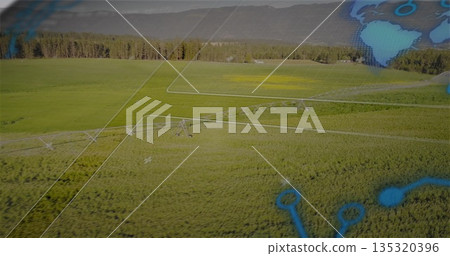 Pivot irrigation system watering crop rows in farmland with white overlay blue nodes and mountains 135320396