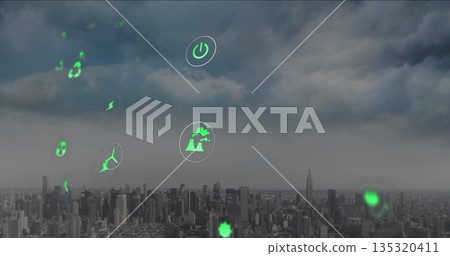 Floating green holographic icons hovering above urban skyline, with wind turbine and lightning bolt Floating green holographic icons hovering above urban skyline, with wind turbine and lightning bolt 135320411