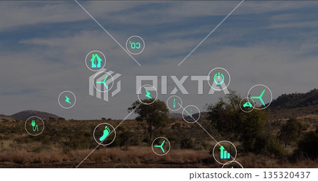 Floating green energy icons hovering above dry grassland plain, with wind turbine plug CO2 icons 135320437