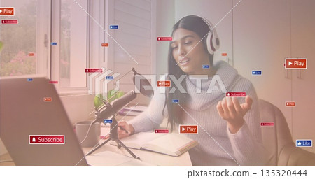 Recording content creator talking at office desk with laptop mic showing Play Subscribe Like icons Recording content creator talking at office desk with laptop mic showing Play Subscribe Like icons 135320444