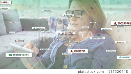 Holding tablet and stylus, woman interacting on living room sofa with floating notification labels Holding tablet and stylus, woman interacting on living room sofa with floating notification labels 135320448